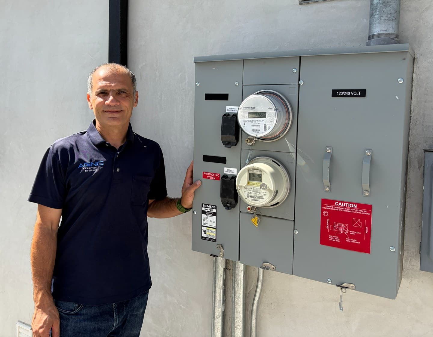 Erik, licensed C-10 electrician and owner of AGNG Electric, at a service panel in Los Angeles